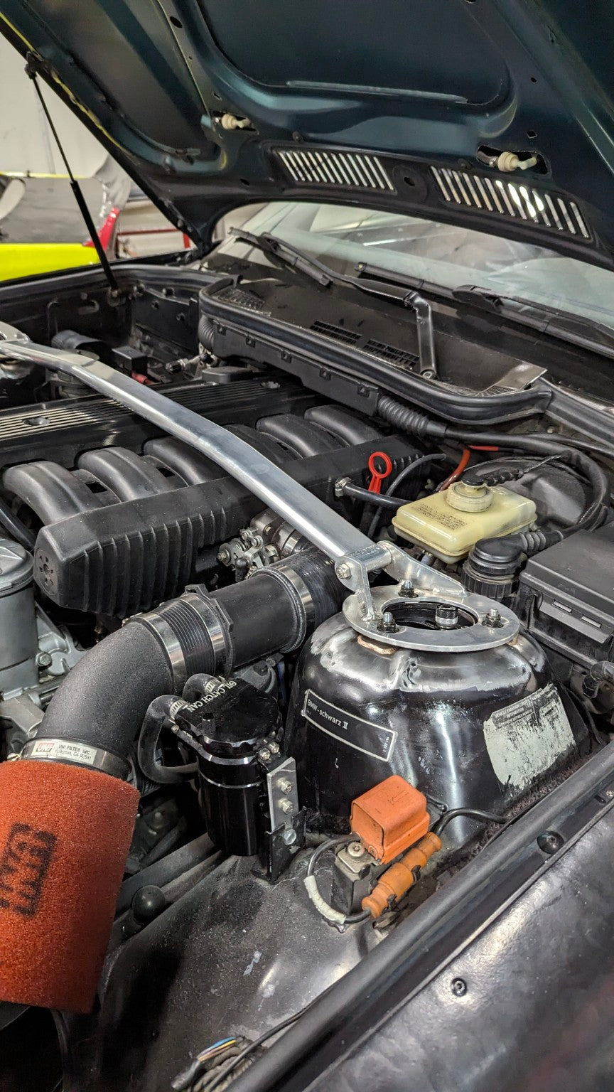 BMW E36 race-car engine bay with intake, strut brace and catch-can system