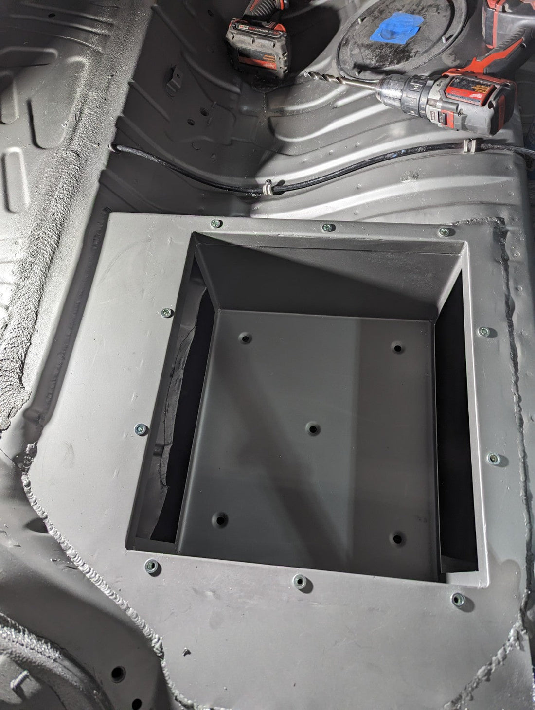 Custom recessed fuel-cell cradle fabricated into a race-car floor