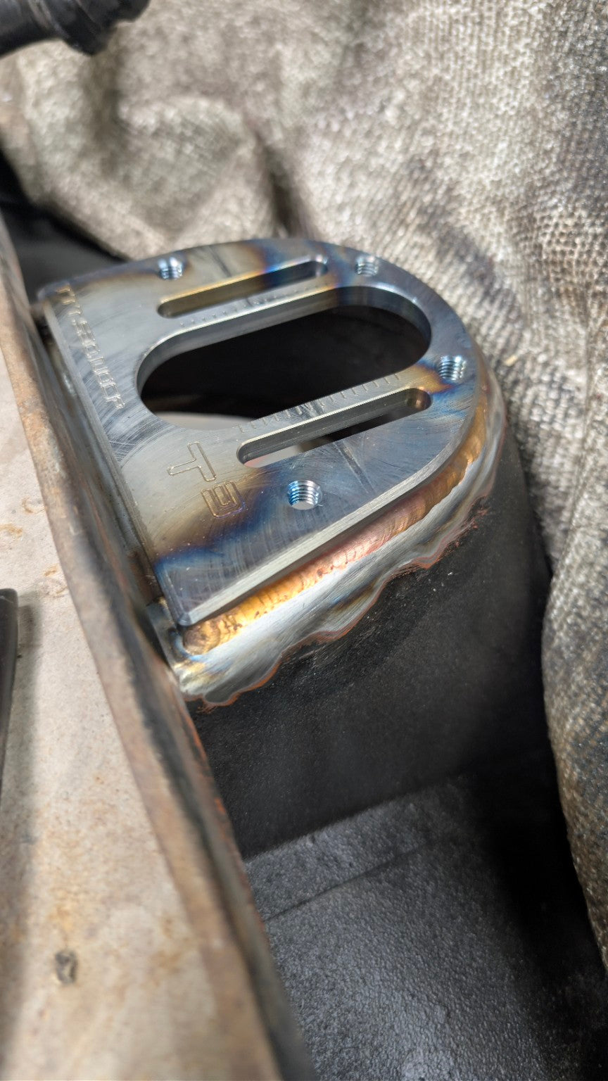 Welded steel reinforcement plate fabricated into a race car chassis