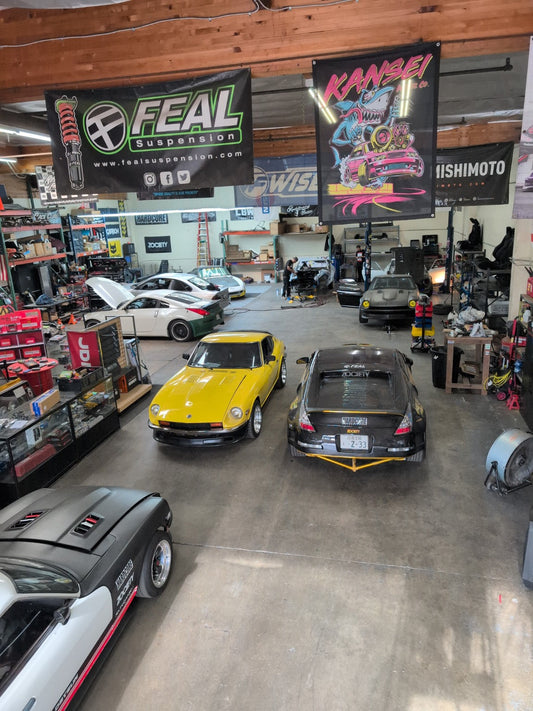 Race Club Fabrication shop filled with active race car builds