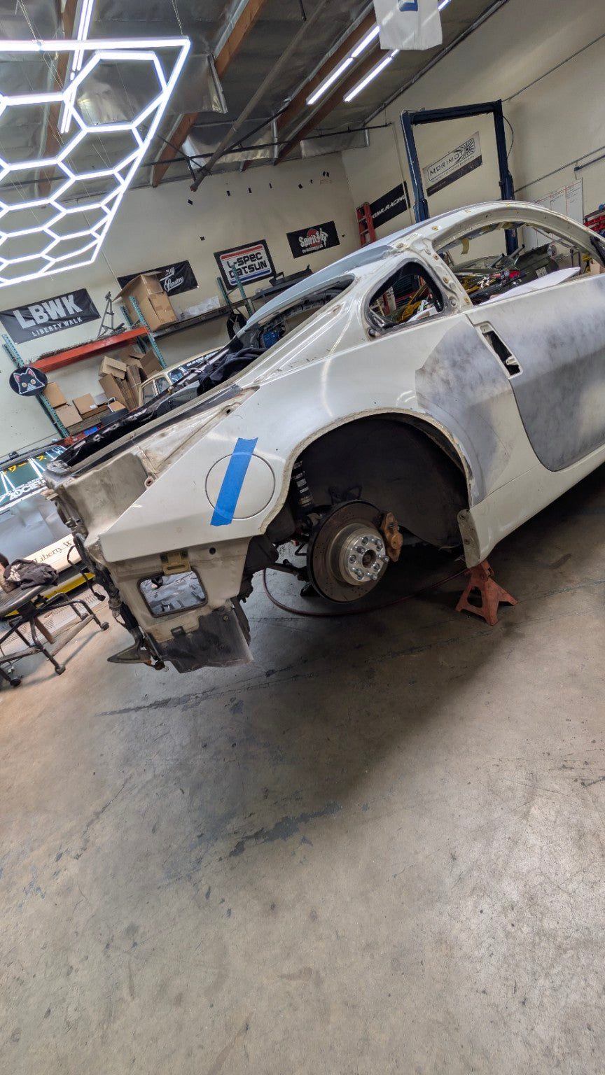Race Club Liberty Walk Nissan 350Z SEMA build undergoing widebody preparation inside the Race Club Fabrication shop
