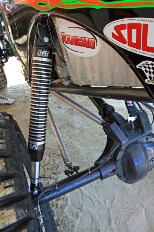 Long-travel suspension on a rock racer; representative off-road suspension photograph. Photo by oristruts.com / Wikimedia Commons, CC0.