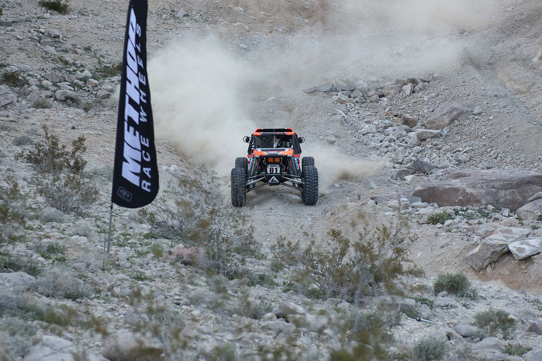 King of the Hammers 2019 off-road race action in Johnson Valley; representative desert-racing terrain and tire-load image. Bureau of Land Management / Wikimedia Commons, public domain.