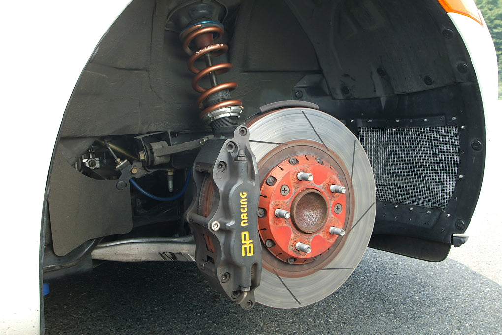 AP Racing disc brake; representative competition-brake photograph used for race-car brake-cooling discussion. Photo by Tennen-Gas / Wikimedia Commons, CC BY-SA 3.0.
