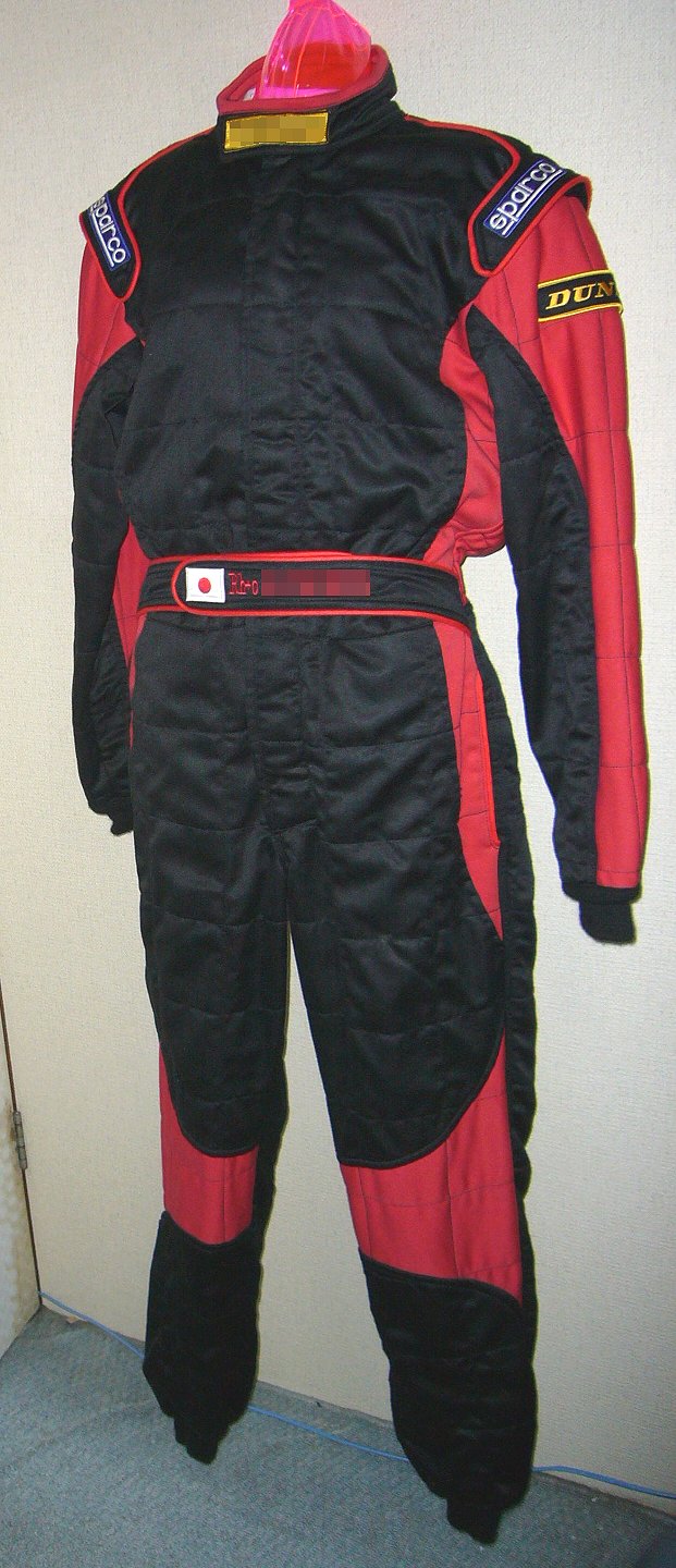 Three-layer Sparco racing suit photographed in 2007; representative fire-resistant racing apparel image, not proof of current 2026 certification. Wikimedia Commons, public domain.