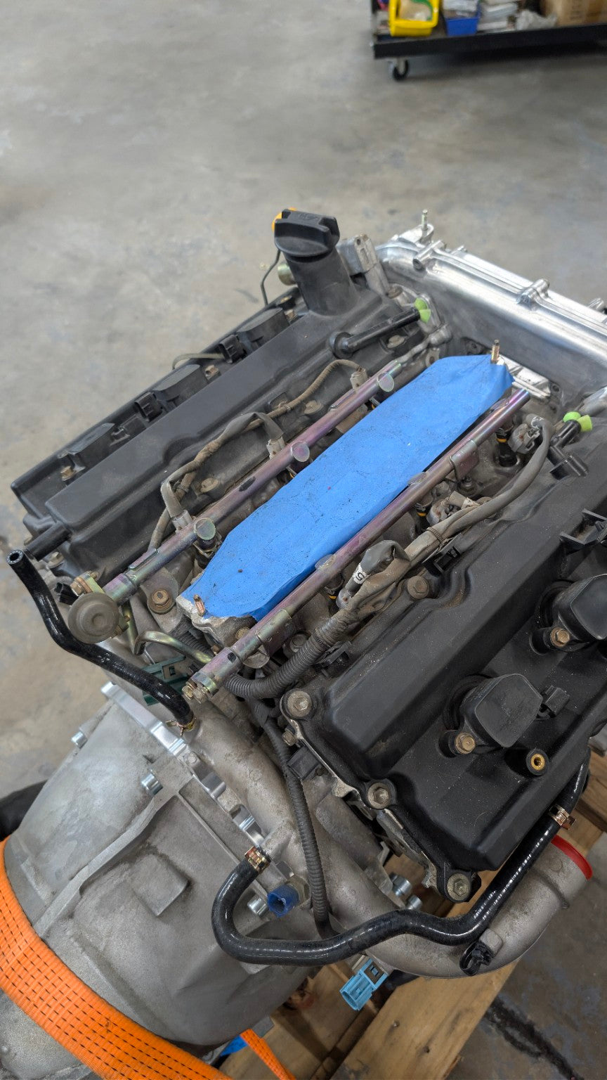 VQ35DE engine and ZF 8HP50 transmission assembly in the Race Club shop before Datsun 280Z header-clearance fabrication.