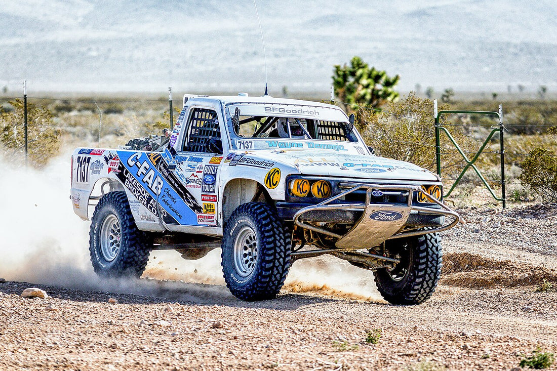 Archive Mint 400 off-road race truck driving across rocky desert terrain; representative image for Baja 1000 navigator preparation, not the 2026 Baja 1000.