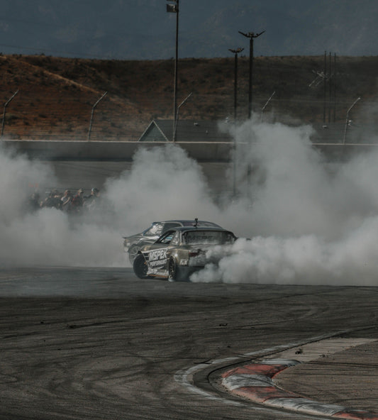 Two cars drifting through tire smoke; representative photograph by Jacob Moore, not the September 2026 Formula DRIFT Las Vegas event.