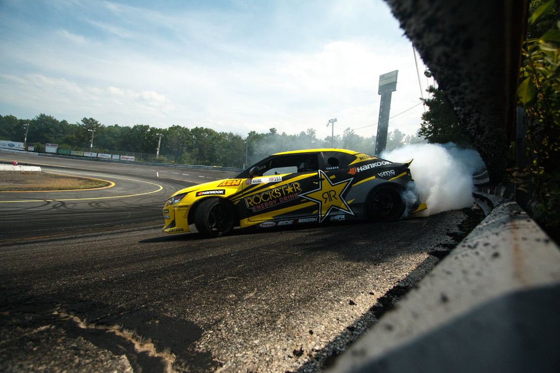 Archive Formula DRIFT action: Fredric Aasbo brushes the wall in his 2015 Scion tC; representative Formula DRIFT image, not the 2026 Las Vegas event.