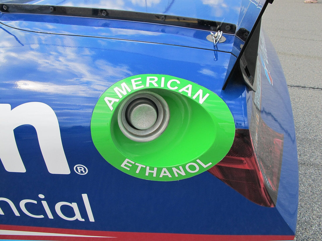 Close view of the dry-break fuel filler on a NASCAR stock car; representative race-fuel-system photo, not an FIA 8875-2025 label.