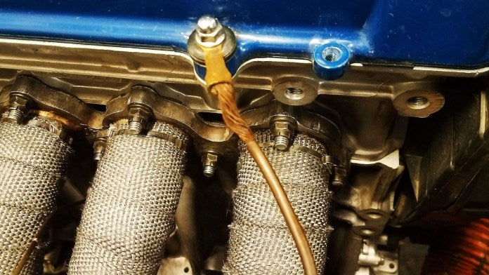 Race car braided engine ground strap and protected wiring