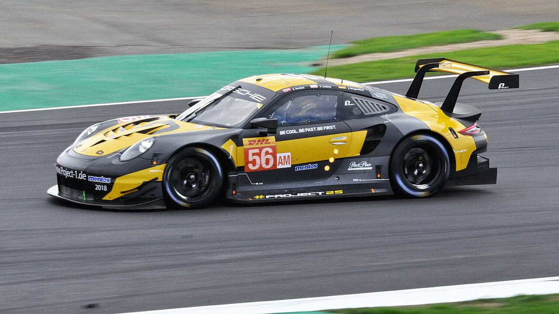 The yellow and black number 56 Team Project 1 Porsche 911 RSR cornering at Silverstone in 2018.