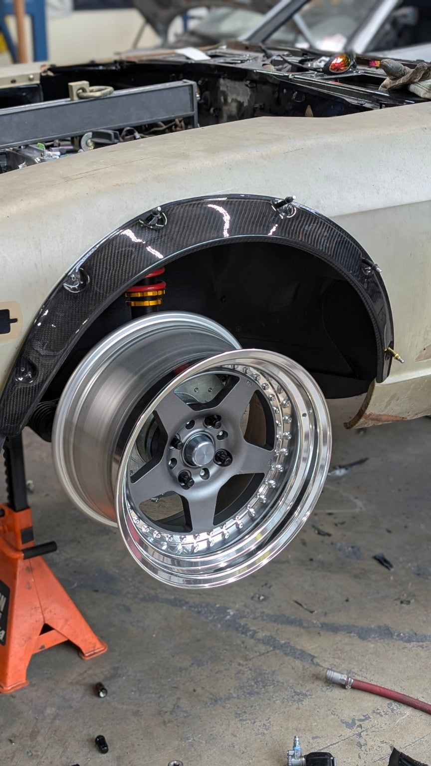 Wide wheel mocked up beneath the carbon-fiber front arch extension on the Race Club Datsun 280Z SEMA build