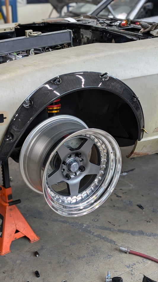 Wide wheel mocked up beneath the carbon-fiber front arch extension on the Race Club Datsun 280Z SEMA build