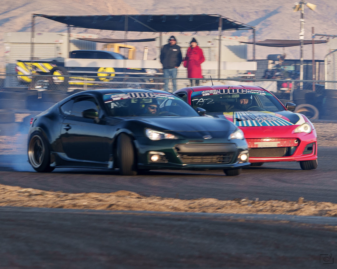 Two Ultimate Drifting Challenge cars in a close tandem battle at a UDC event; supplied UDC event photography.
