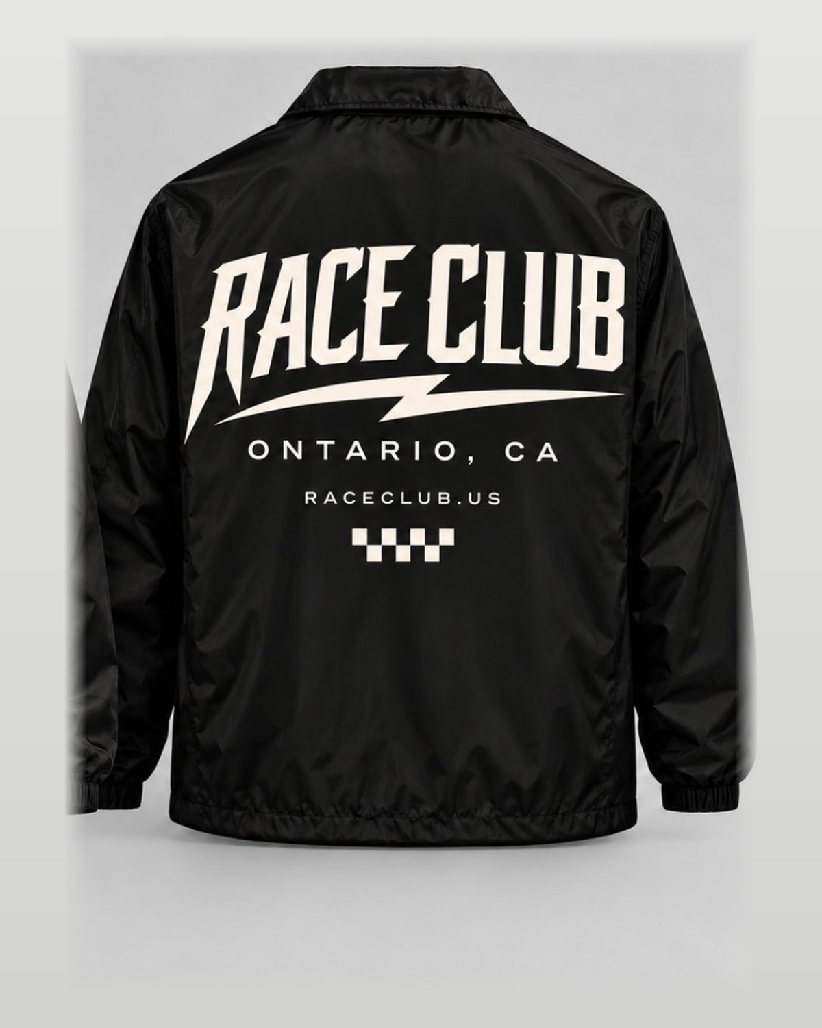 Rear view of Race Club black coach jacket showing oversized cream Race Club Ontario CA graphic