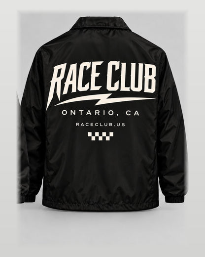 Rear view of Race Club black coach jacket showing oversized cream Race Club Ontario CA graphic